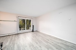 Light-toned wood-finish flooring complements the neutral wall color - 