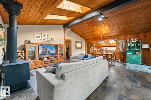Vaulted wood-paneled ceiling with skylights, wood-burning stove, and slate-finish flooring - #421 61209 Rge Rd 465, Rural Bonnyville M.D., AB 