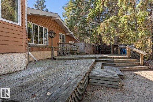 Multi-level deck and stone patio surrounded by mature trees - #421 61209 Rge Rd 465, Rural Bonnyville M.D., AB 