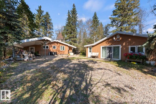 Two separate structures with brown siding and white trim, set amidst mature trees - #421 61209 Rge Rd 465, Rural Bonnyville M.D., AB 