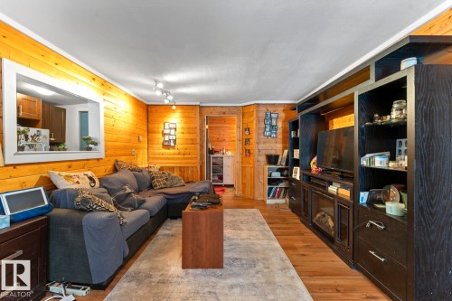 Wood-paneled walls and wood-finish flooring - #421 61209 Rge Rd 465, Rural Bonnyville M.D., AB 