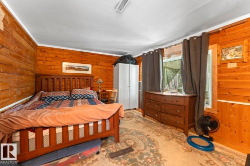 Wood paneling, bright white ceiling, and window with dark drapery - #421 61209 Rge Rd 465, Rural Bonnyville M.D., AB 
