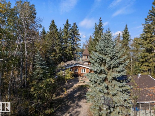 Wood-sided exterior with white window frames, a metal roof, and a prominent turret - #421 61209 Rge Rd 465, Rural Bonnyville M.D., AB 