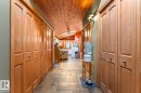 Wood-finish bi-fold doors, wood-paneled ceiling, recessed lighting, and tile flooring - #421 61209 Rge Rd 465, Rural Bonnyville M.D., AB 