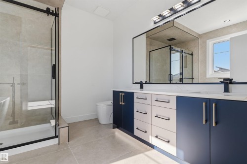 Dual vanity with a white countertop and contrasting navy and white cabinetry - 2720 63 Avenue, Rural Leduc County, AB 