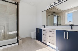 Dual vanity with a white countertop and contrasting navy and white cabinetry - 