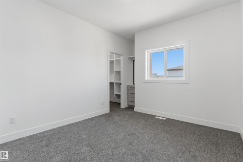 Grey carpeted flooring, white walls, and a window with white trim - 2720 63 Avenue, Rural Leduc County, AB 