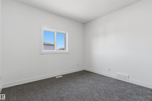 Light gray wall paint, white trim, and gray carpeted flooring - 2720 63 Avenue, Rural Leduc County, AB 