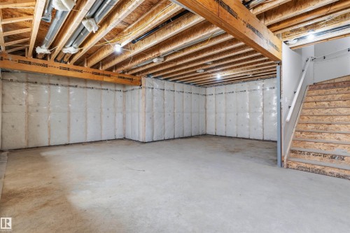 Unfinished basement featuring exposed wood joists, concrete flooring, and insulated perimeter walls - 2720 63 Avenue, Rural Leduc County, AB 