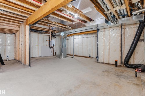 Unfinished basement with exposed ceiling joists, concrete flooring, and insulated perimeter walls - 2720 63 Avenue, Rural Leduc County, AB 