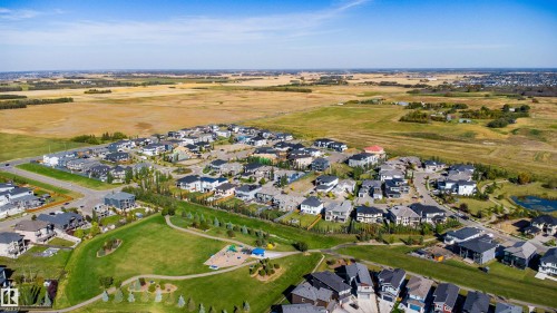 Residential neighborhood with modern homes, expansive green spaces, and a playground - 2720 63 Avenue, Rural Leduc County, AB 