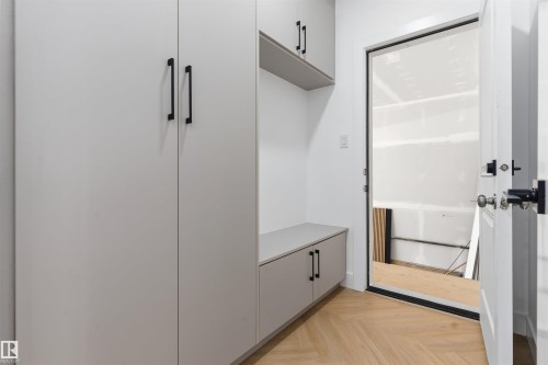 Built-in cabinetry with matte black hardware, integrated shelving, and a built-in bench - 2720 63 Avenue, Rural Leduc County, AB 