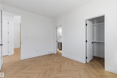 Herringbone wood-finish flooring, crisp white walls, and bright overhead lighting - 2720 63 Avenue, Rural Leduc County, AB 