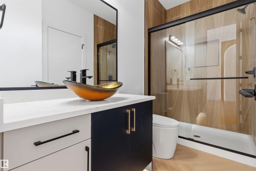 Modern vanity with a vessel sink, quartz countertop, and black fixtures - 2720 63 Avenue, Rural Leduc County, AB 