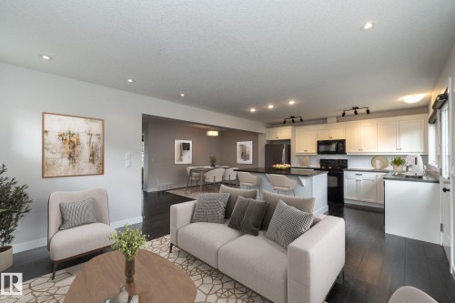 Recessed and track lighting illuminate the dark wood-finish flooring - 55 Michigan Street, Devon, AB 