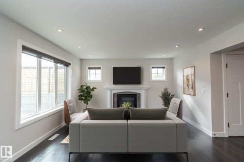 Recessed ceiling lighting, dark wood-finish flooring, and white trim - 55 Michigan Street, Devon, AB 