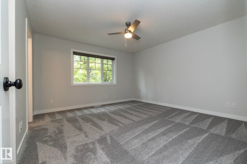 Neutral gray walls complement the patterned gray carpet - 55 Michigan Street, Devon, AB 