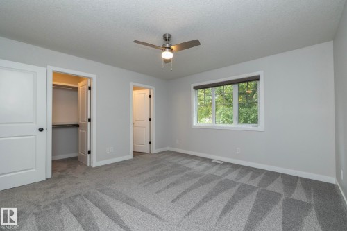 Room featuring textured carpeting, a flush-mount ceiling fan, and a window with blinds - 55 Michigan Street, Devon, AB 