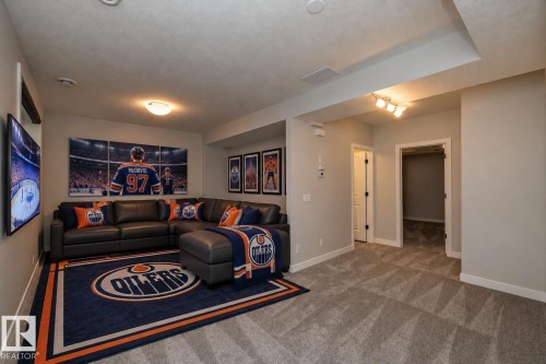 Recessed lighting, wall-mounted television, neutral wall color, and carpeted flooring throughout - 55 Michigan Street, Devon, AB 