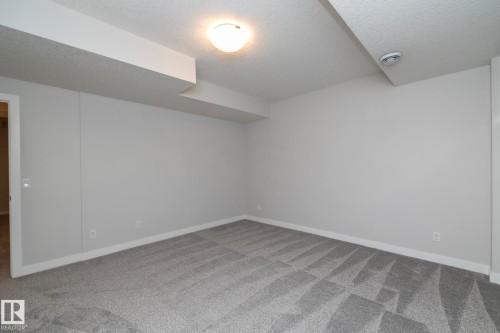 Plush gray patterned carpeting and light gray wall paint - 55 Michigan Street, Devon, AB 