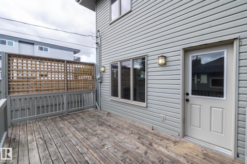 Expansive wooden deck with coordinating wooden railing and privacy lattice - 55 Michigan Street, Devon, AB 