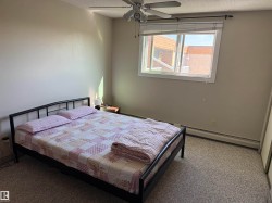 Recessed ceiling fan with light, white window frame, and neutral wall color - 