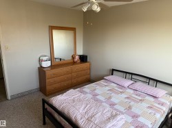 Wall-to-wall carpeting with a ceiling fan featuring integrated lighting - 