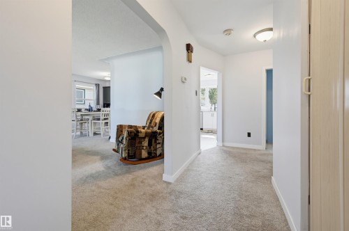 Light-colored wall-to-wall carpeting throughout, arched doorway, and interior passageways - 13655 122 Avenue Nw, Edmonton, AB 