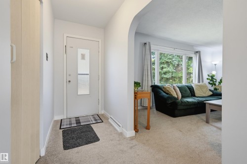 Entry foyer with a white door featuring a frosted glass insert - 13655 122 Avenue Nw, Edmonton, AB 