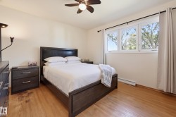 Hardwood flooring and a ceiling fan are complemented by a triple window unit - 