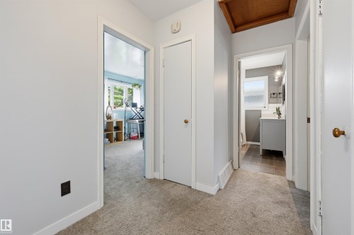Hallway with light gray walls, white trim, and carpet flooring - 13655 122 Avenue Nw, Edmonton, AB 