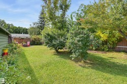 Generous green space with mature trees and established plantings - 