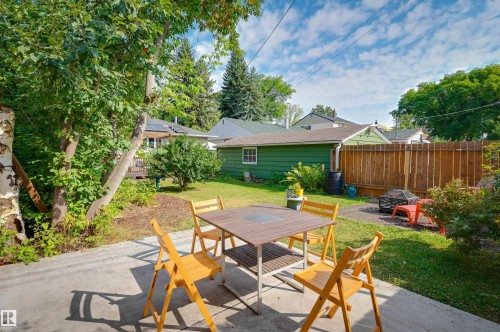 Concrete patio area, manicured lawn, established landscaping, privacy fencing, detached garage structure - 13655 122 Avenue Nw, Edmonton, AB 