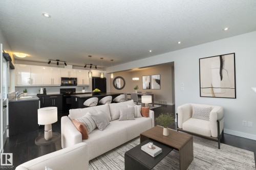 Open-concept living area featuring dark wood-finish flooring and recessed lighting - 53 Michigan Street, Devon, AB 