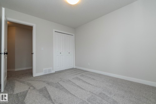 Neutral paint finishes, plush carpeting, bi-fold closet doors, and recessed lighting - 53 Michigan Street, Devon, AB 