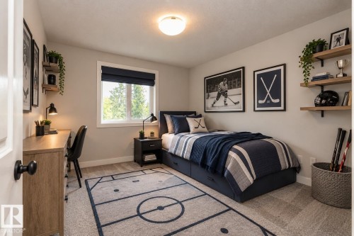 Neutral wall color, window with a dark roller shade, wood-finish desk, built-in shelving, and a flush mount ceiling light - 53 Michigan Street, Devon, AB 