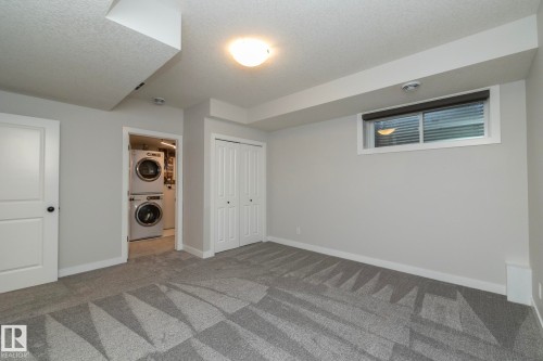 Recessed lighting, patterned carpet flooring, bi-fold closet doors, white trim, and a window with blinds - 53 Michigan Street, Devon, AB 