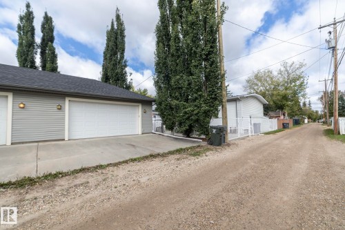 Detached garage with horizontal siding, two garage doors, and a shingled roof - 53 Michigan Street, Devon, AB 