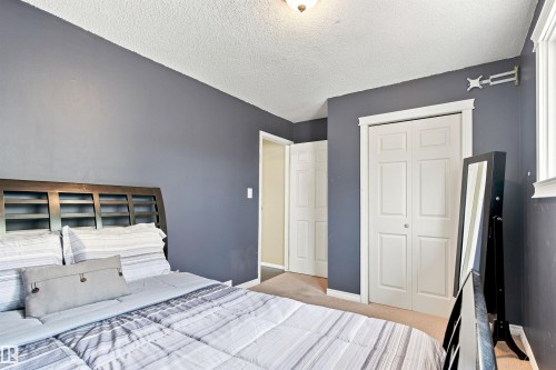 Wall-to-wall carpeting with painted walls and white trim - 12 Hughes Road Nw, Edmonton, AB 