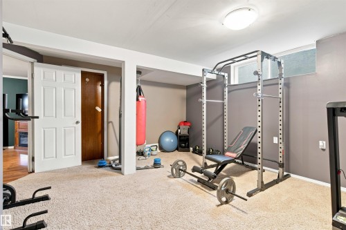 Carpeted flooring, recessed ceiling lighting, and a paneled white door - 12 Hughes Road Nw, Edmonton, AB 