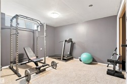 Carpeted room with neutral wall color and an overhead light fixture - 