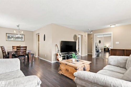 Wood-finish flooring throughout, providing a cohesive aesthetic - 12 Hughes Road Nw, Edmonton, AB 