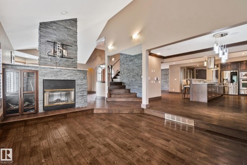 Stone-clad fireplace with glass display cabinetry - 10 Eldorado Drive, St. Albert, AB 