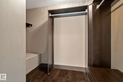 Built-in closet system with hanging rods, wood-finish flooring, and integrated shelving - 10 Eldorado Drive, St. Albert, AB 