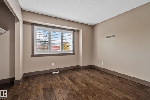 Wood-finish flooring, neutral wall paint, and white plantation shutters - 10 Eldorado Drive, St. Albert, AB 