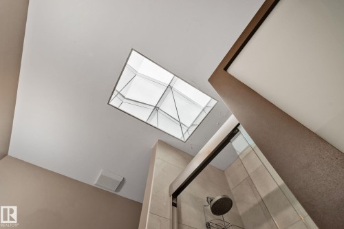 Angled skylight above a shower with a sliding glass door and tiled walls - 10 Eldorado Drive, St. Albert, AB 