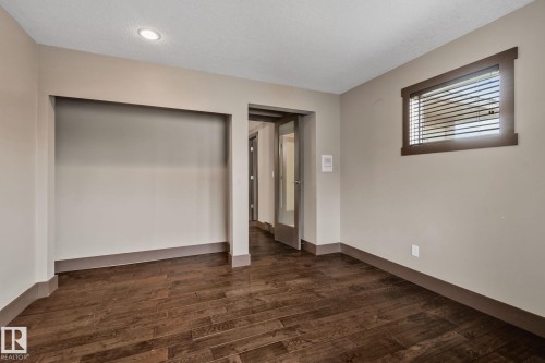 Wood-finish flooring, recessed lighting, built-in open shelving, interior glass-paneled door, and a window with blinds - 10 Eldorado Drive, St. Albert, AB 