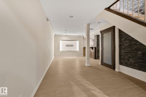 Wood-finish flooring throughout, recessed lighting, and a built-in electric fireplace - 10 Eldorado Drive, St. Albert, AB 