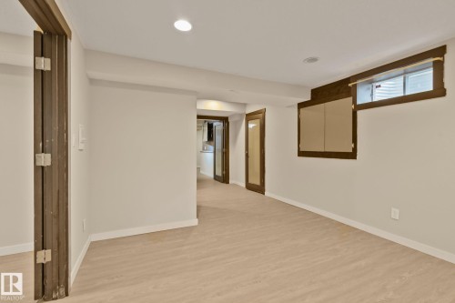 Wood-finish flooring, recessed lighting, and a window with a wood frame - 10 Eldorado Drive, St. Albert, AB 