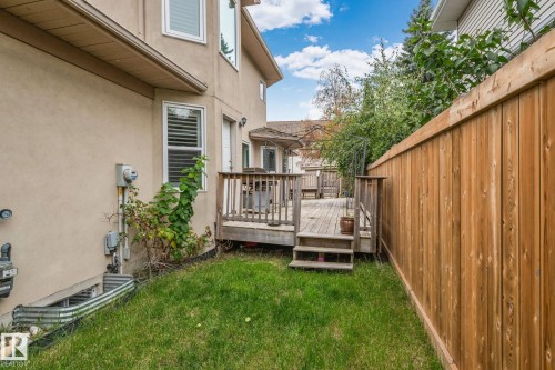 Wood deck with railings and steps, alongside a privacy fence, and grass area - 10 Eldorado Drive, St. Albert, AB 